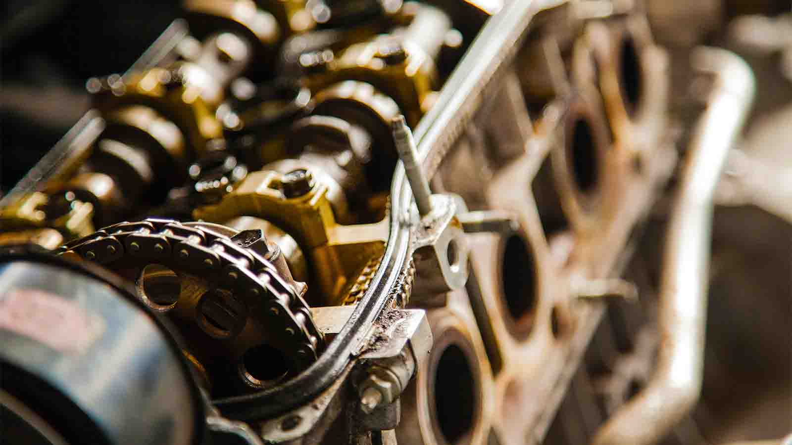 What parts of the engine does oil lubricate?